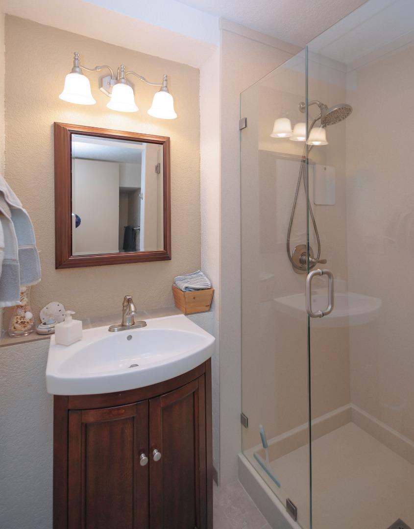 803 Big Bend Drive Pacifica, CA 94044 - Photo 27 of 47 a bathroom with a sink a mirror and shower
