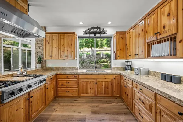 a kitchen with stainless steel appliances granite countertop a refrigerator and a stove