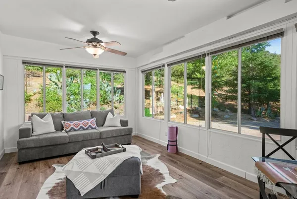 a view of hallway with wooden floor and windows
