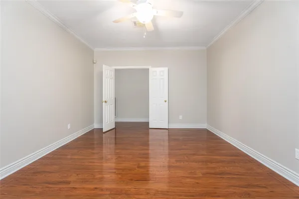 a view of an empty room with wooden floor