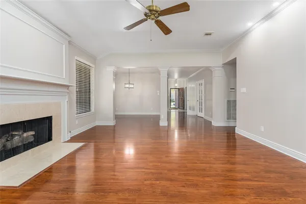 a view of a livingroom with wooden floor and a fireplace