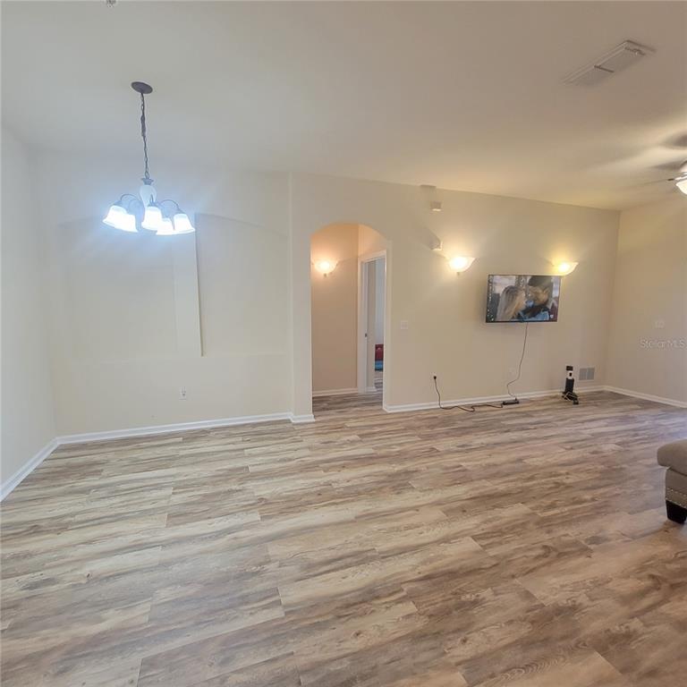 3351 Whitestone Circle, Unit 105 Kissimmee, FL 34741 - Photo 11 of 22 a view of a room with wooden floor and kitchen view