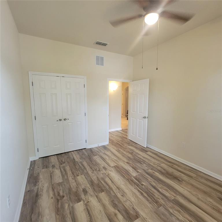 3351 Whitestone Circle, Unit 105 Kissimmee, FL 34741 - Photo 15 of 22 a view of an empty room with wooden floor