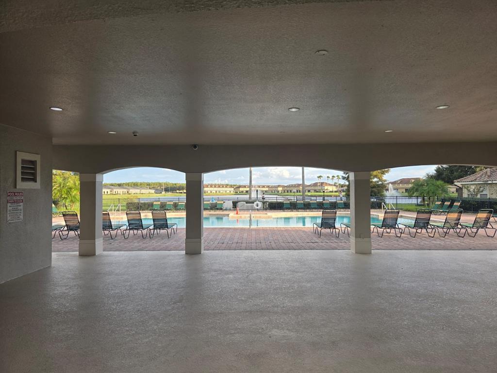 3351 Whitestone Circle, Unit 105 Kissimmee, FL 34741 - Photo 4 of 22 a view of an empty room with a floor to ceiling window and an outdoor view