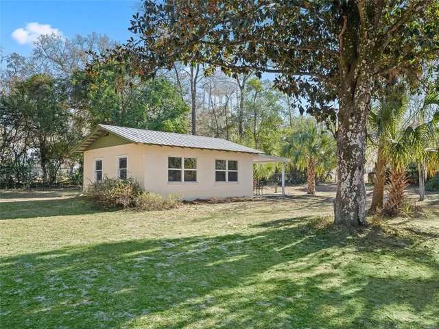 an aerial view of a houses with a yard