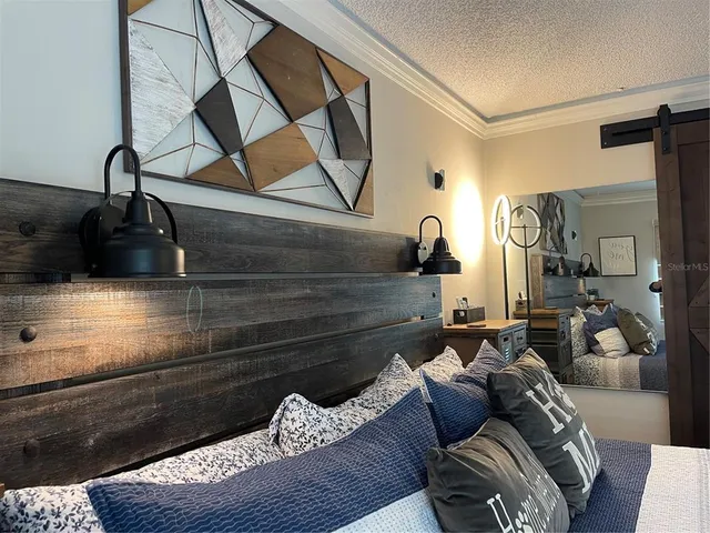 a bed room with a bed and a painting on the wall