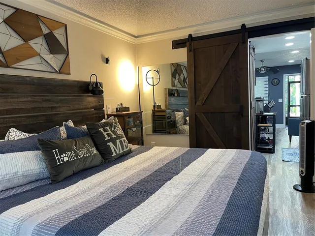 a bedroom with a bed and a chandelier