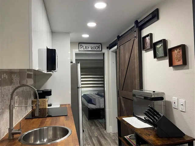 a kitchen with a sink appliances and cabinets