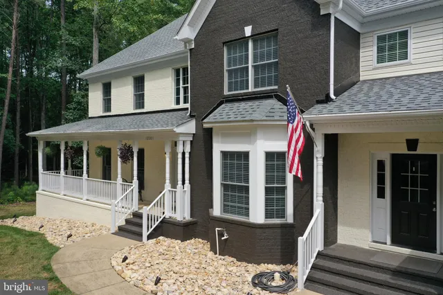 a view of a dining room with furniture a chandelier and wooden floor