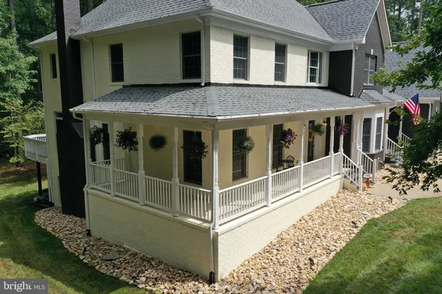 a dining room with wooden floor a chandelier a glass table and chairs