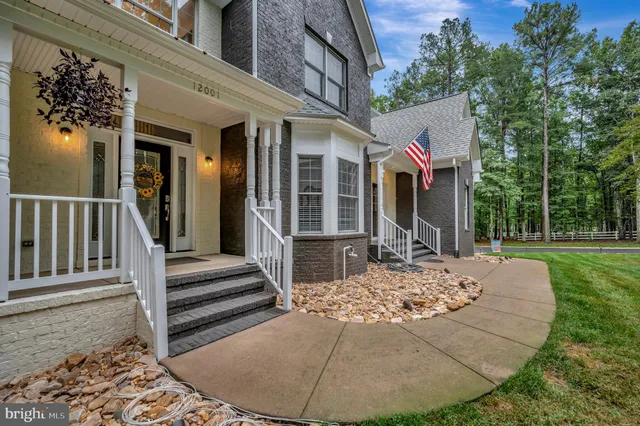 a kitchen with kitchen island granite countertop wooden floors wooden cabinets a center island and stainless steel appliances