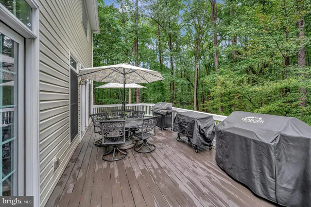 a bathroom with a granite countertop sink and a large mirror
