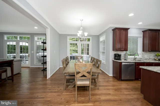 a living room with furniture and a view of kitchen