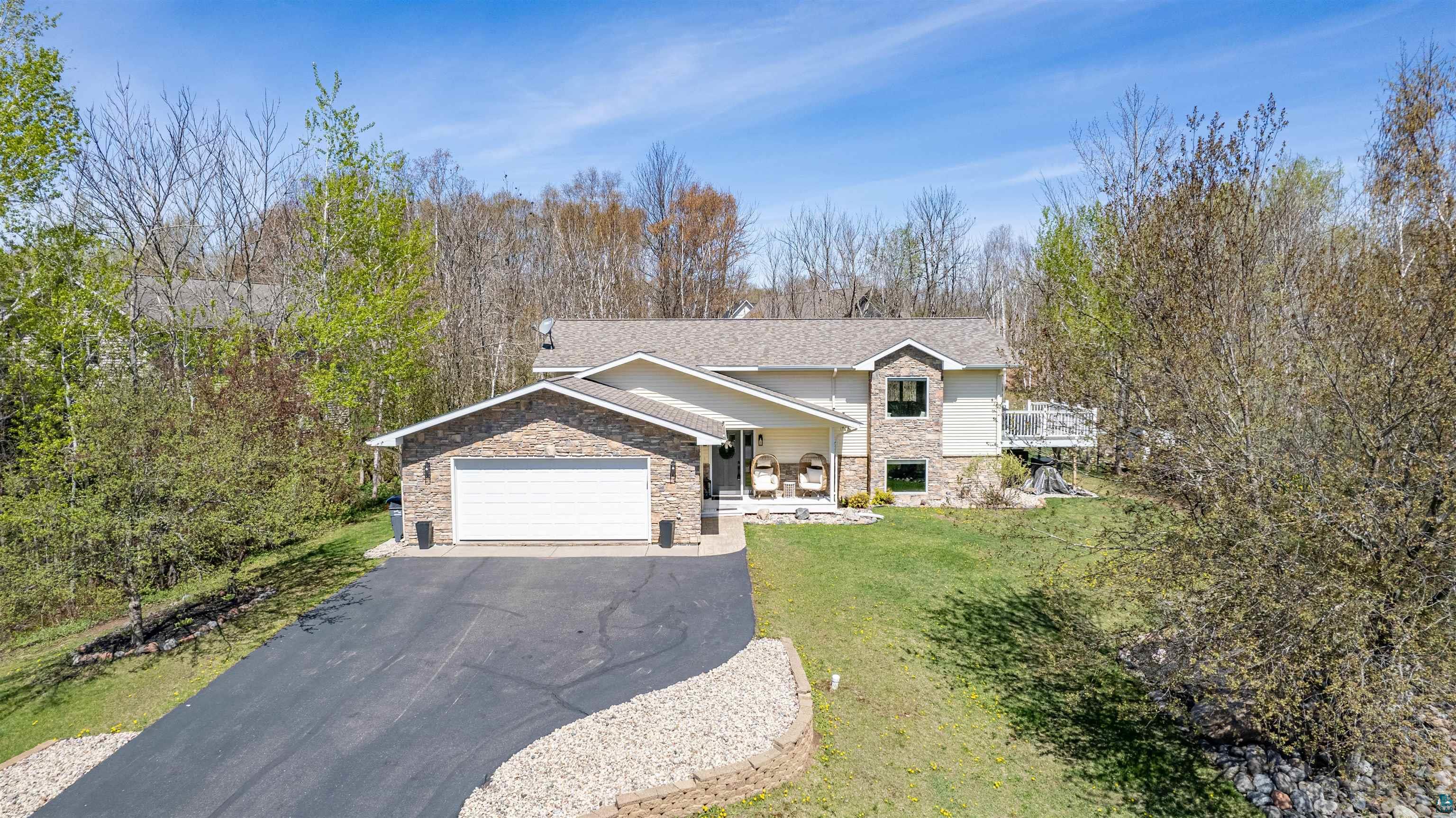 4809 Oak Ridge Drive Hermantown, MN 55811 - Photo 2 of 69 Stone and siding exterior with an attached two-car garage
