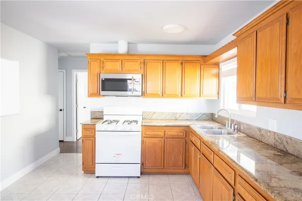 a kitchen with a sink window and cabinets
