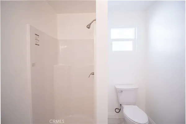 a white toilet sitting next to a bathroom sink
