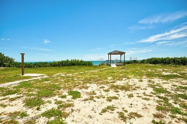 a view of a large body of water with a building in the background
