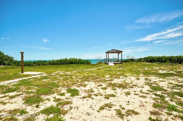 a view of a large body of water with a building in the background