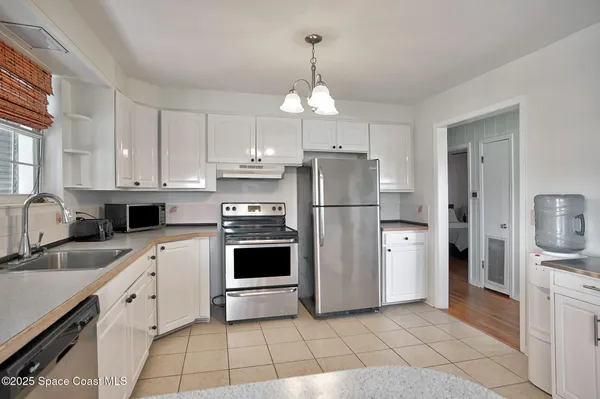 a kitchen with a refrigerator a sink and cabinets