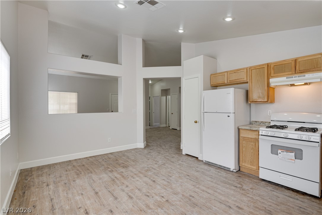 9660 Crystal Ridge Road Las Vegas, NV 89123 - Photo 12 of 13 A well-appointed kitchen and living space featuring practical flooring and high ceilings.