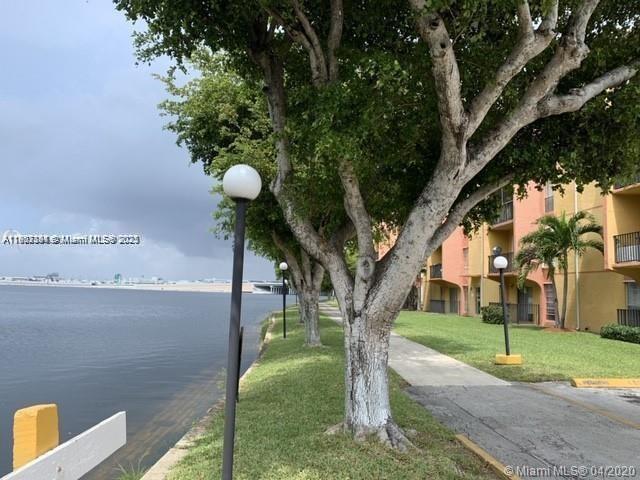 4803 Northwest 7th Street, Unit 40314 Miami, FL 33126 - Photo 14 of 16 a view of a tree in front of a house