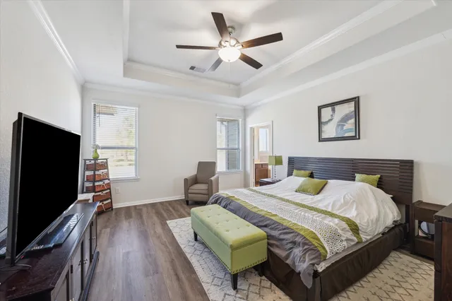 a bedroom with a bed and a flat screen tv