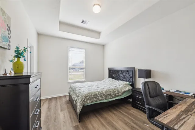 a bedroom with a bed and a dresser