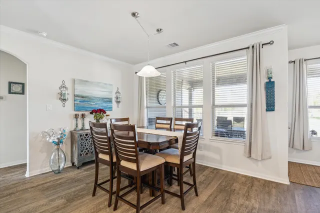 a view of a dining room with furniture and wooden floor
