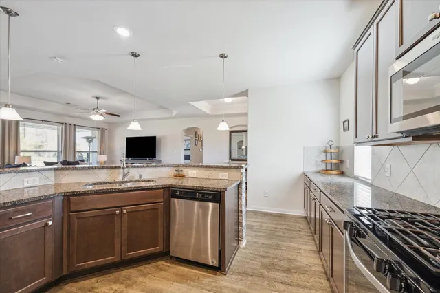 a kitchen with a sink stove and cabinets