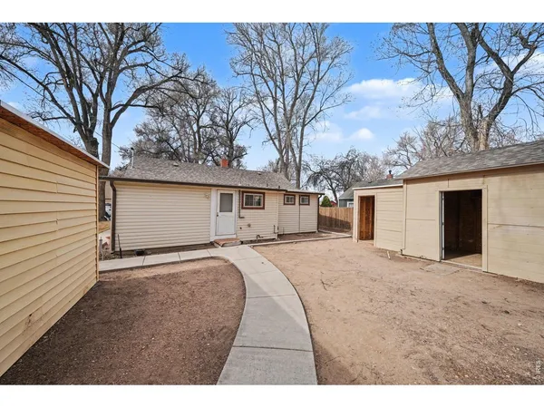 a view of white house with a yard covered in snow