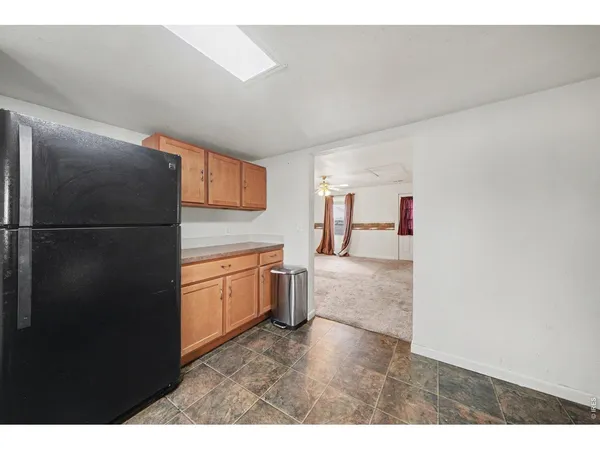 a kitchen with a refrigerator and a sink