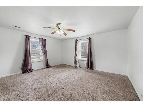 a view of a livingroom with a ceiling fan