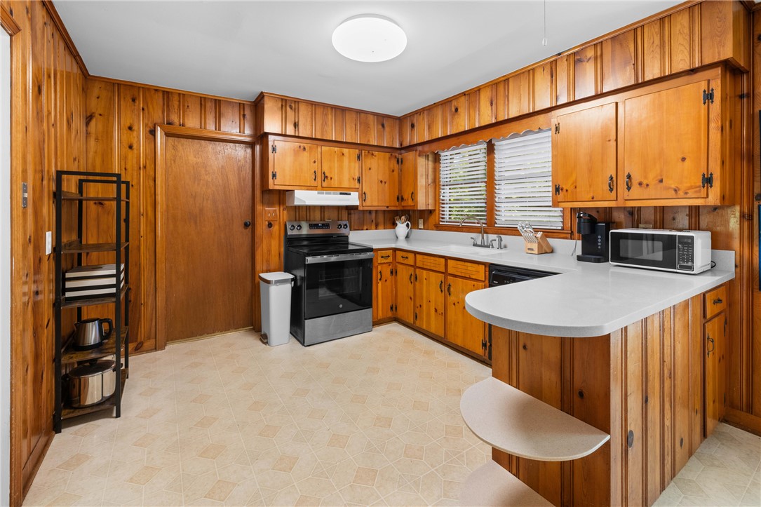 207 Brook Street Clemson, SC 29631 - Photo 14 of 39 Bright, cozy kitchen with classic wooden cabinetry and practical, durable flooring.