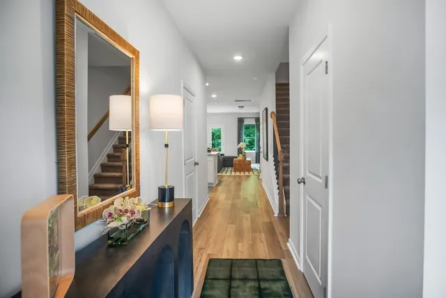 a hallway with a large mirror and furniture