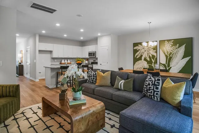 a living room with furniture and a chandelier