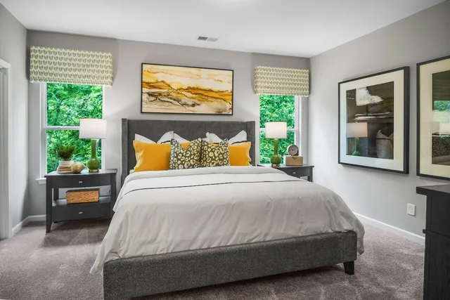 a bedroom with a bed and a large window