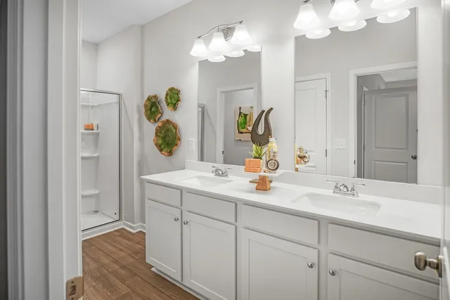 a bathroom with a sink double vanity granite and a mirror