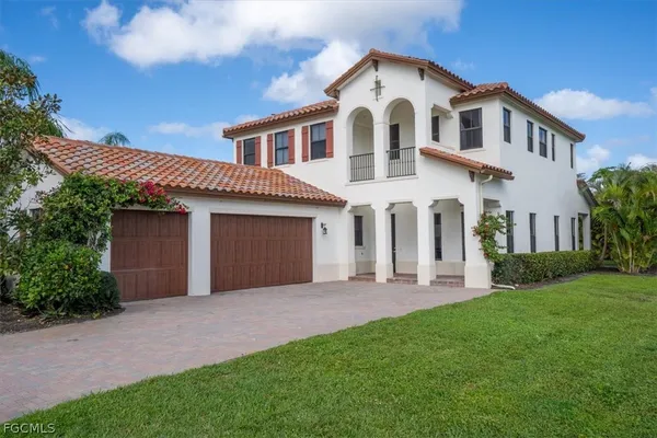 a front view of a house with a garden and yard