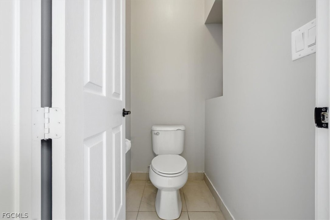 5245 Messina Street Ave Maria, FL 34142 - Photo 22 of 44 a white toilet sitting next to a shower