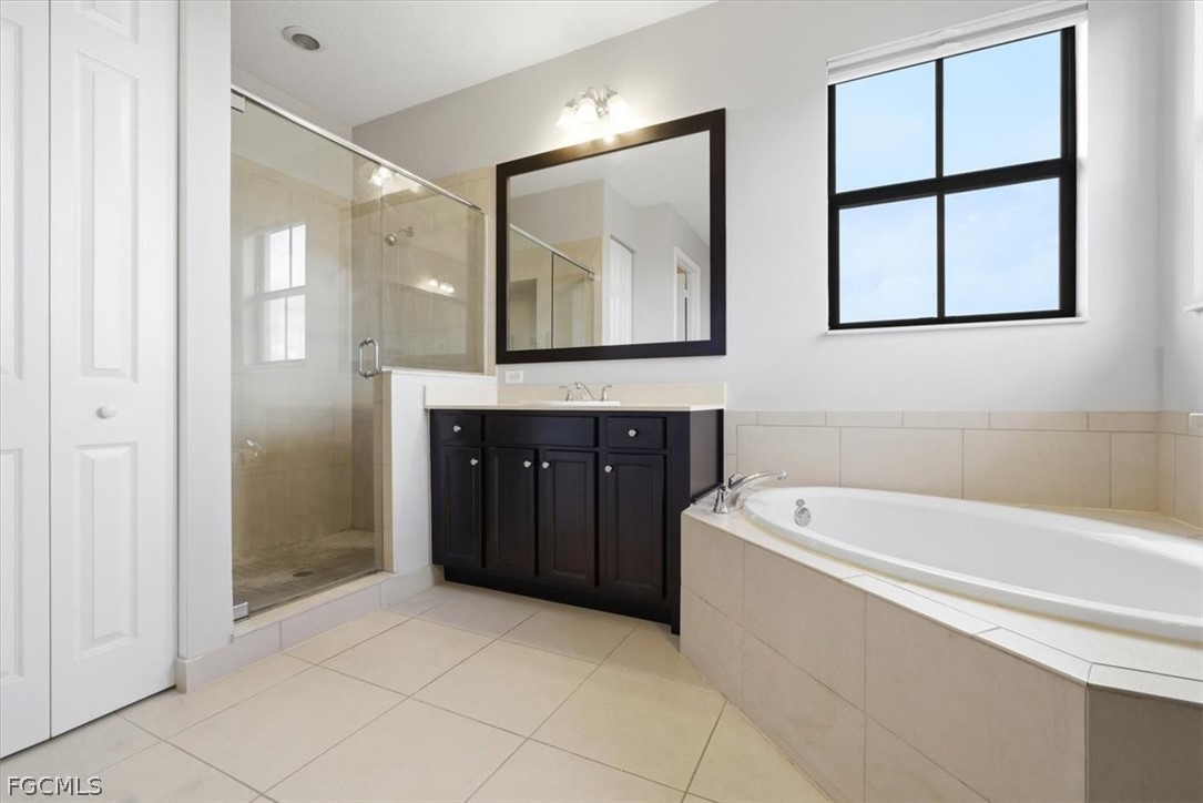 5245 Messina Street Ave Maria, FL 34142 - Photo 23 of 44 a spacious bathroom with a tub sink and mirror
