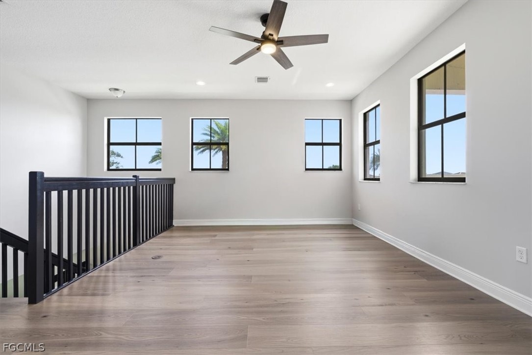 5245 Messina Street Ave Maria, FL 34142 - Photo 25 of 44 a view of empty room with wooden floor and fan