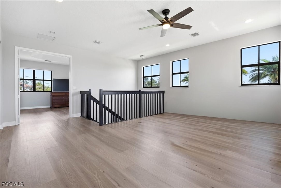 5245 Messina Street Ave Maria, FL 34142 - Photo 26 of 44 a view of a livingroom with a hardwood floor and a ceiling fan