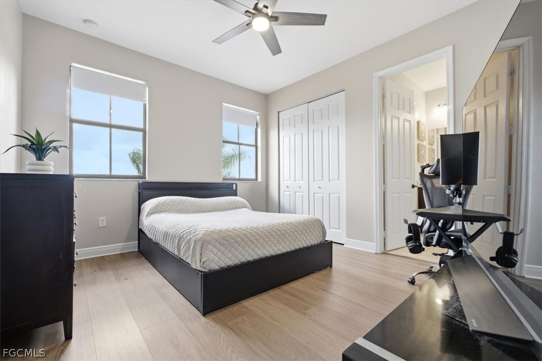 5245 Messina Street Ave Maria, FL 34142 - Photo 27 of 44 a bedroom with a bed and a chandelier