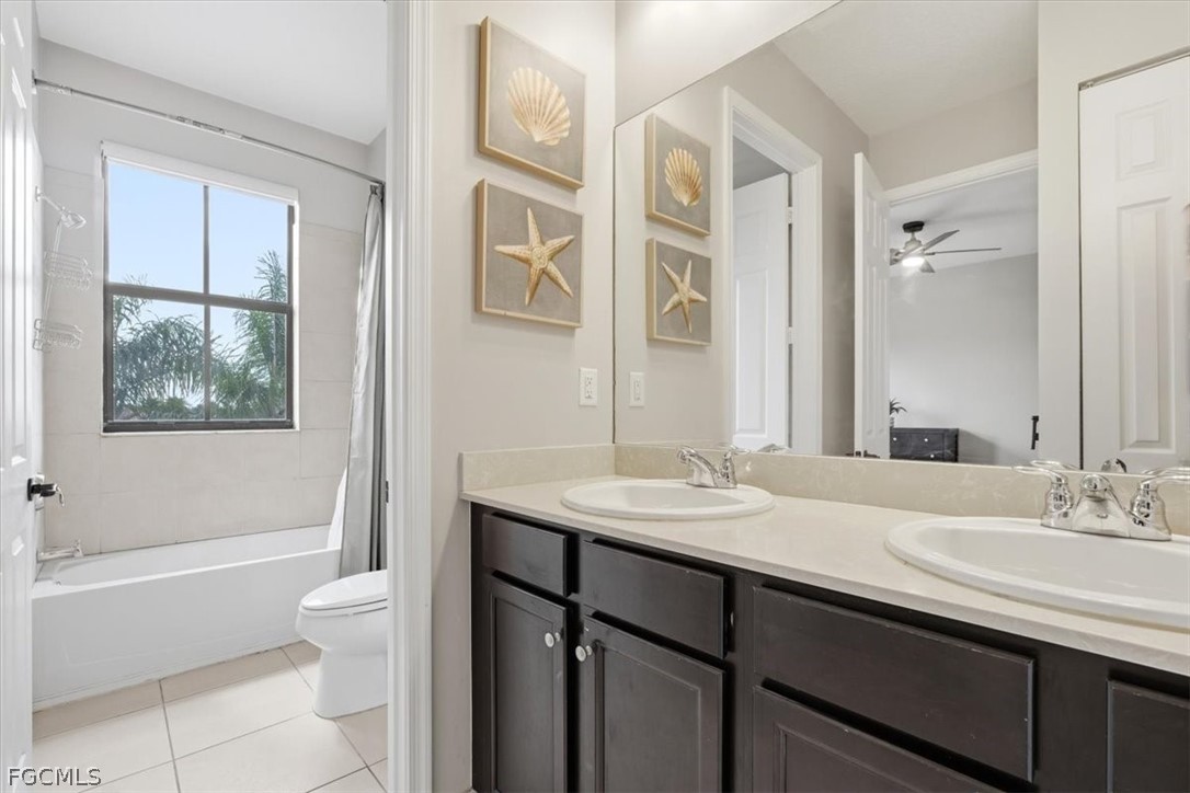 5245 Messina Street Ave Maria, FL 34142 - Photo 30 of 44 a bathroom with a granite countertop sink toilet and shower