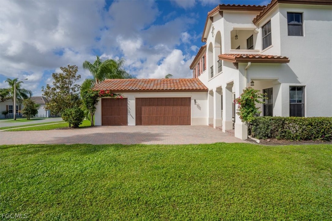 5245 Messina Street Ave Maria, FL 34142 - Photo 3 of 44 front view of a house with a yard