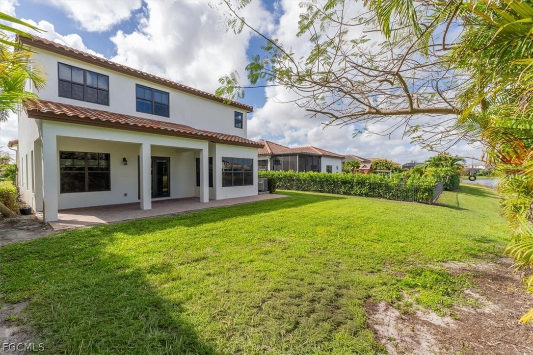 5245 Messina Street Ave Maria, FL 34142 - Photo 35 of 44 a view of a house with a yard