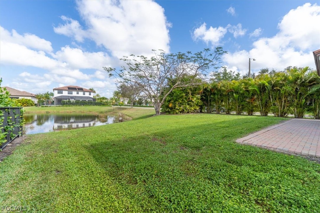 5245 Messina Street Ave Maria, FL 34142 - Photo 36 of 44 a view of a lake with a big yard