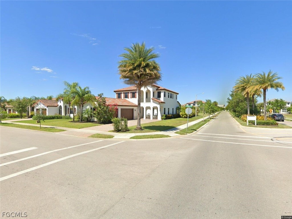 5245 Messina Street Ave Maria, FL 34142 - Photo 39 of 44 a view of swimming pool with outdoor seating and house in the background