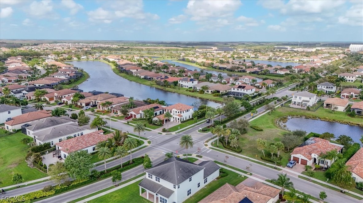 5245 Messina Street Ave Maria, FL 34142 - Photo 40 of 44 an aerial view of lake and residential houses with outdoor space