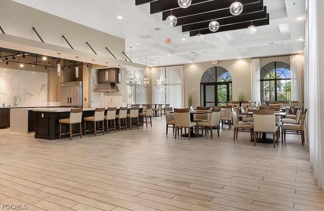 5245 Messina Street Ave Maria, FL 34142 - Photo 42 of 44 a lobby with furniture and wooden floor
